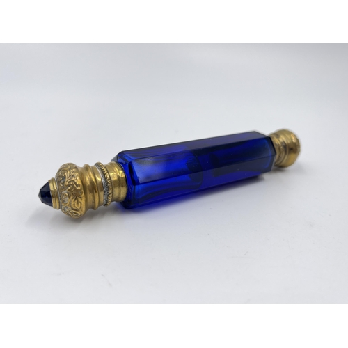 2254 - A Victorian blue glass double ended scent bottle with gilt metal tops - approx. 12cm long