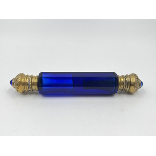 2254 - A Victorian blue glass double ended scent bottle with gilt metal tops - approx. 12cm long