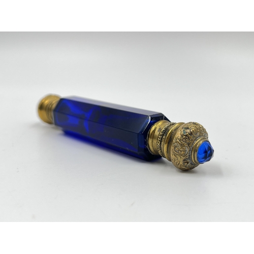 2254 - A Victorian blue glass double ended scent bottle with gilt metal tops - approx. 12cm long