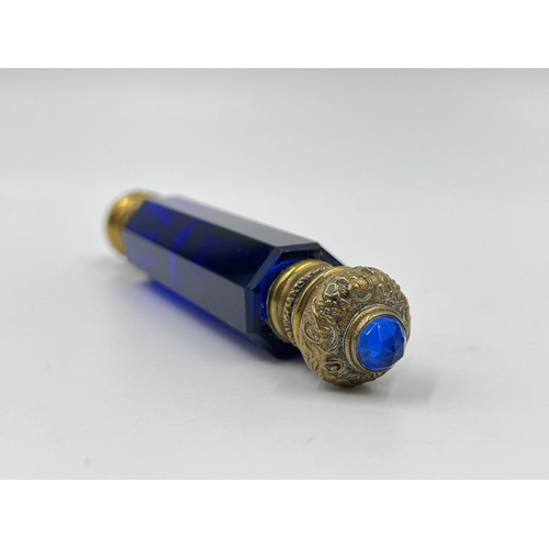 2254 - A Victorian blue glass double ended scent bottle with gilt metal tops - approx. 12cm long