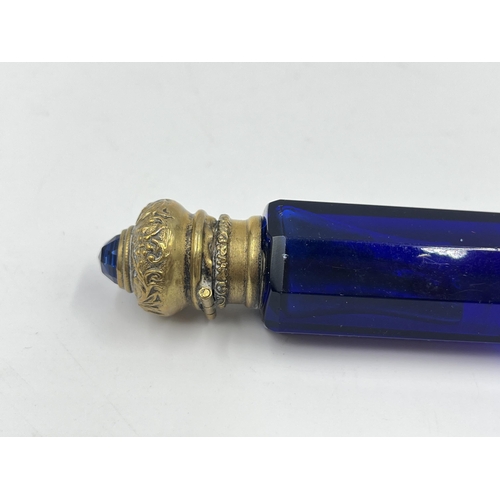 2254 - A Victorian blue glass double ended scent bottle with gilt metal tops - approx. 12cm long