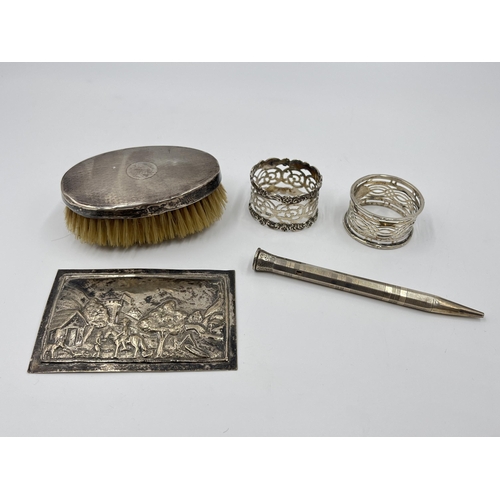 2265 - Five silver and white metal items to include two hallmarked Birmingham silver napkin rings, hallmark... 