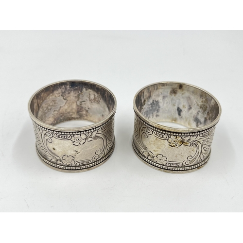 2275 - Three hallmarked sterling silver napkin rings, a pair of Birmingham dated 1908 and one Chester dated... 