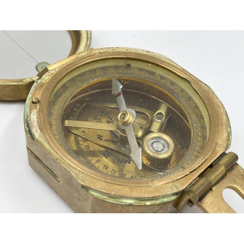 1259 - Three navigational instruments, one wood and brass cased Nauticalia Captain Cook brass focus magnifi... 