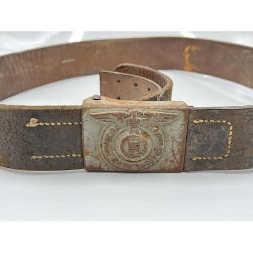 1275 - A WWII leather belt with German SS pressed metal buckle