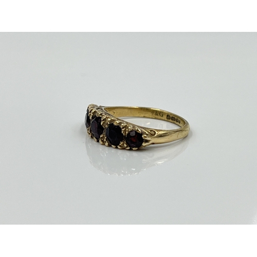 1124 - A hallmarked Birmingham 9ct gold garnet five stone ring, dated 1977, size L½ - approx. gross weight ... 