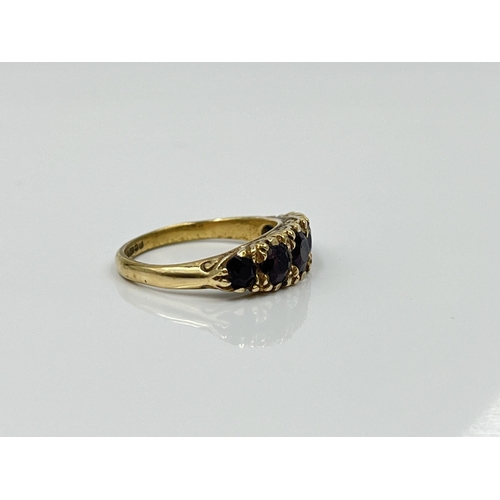 1124 - A hallmarked Birmingham 9ct gold garnet five stone ring, dated 1977, size L½ - approx. gross weight ... 