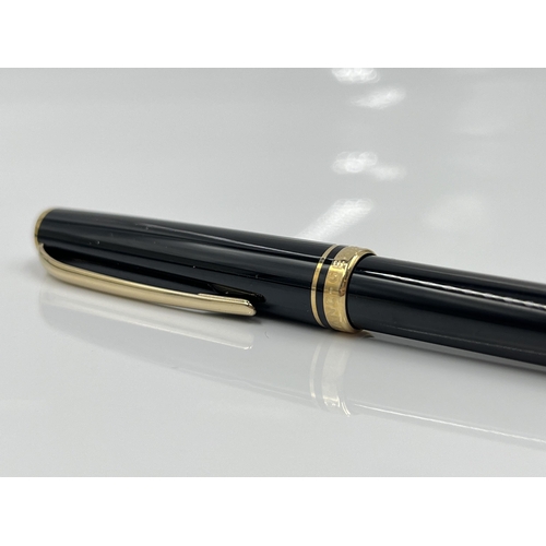 1262 - A boxed Mont Blanc Generation black ballpoint pen with warranty card and service guide - model no. 1... 