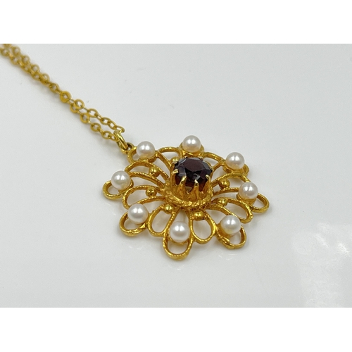 1128 - A yellow metal chain necklace with hallmarked London 9ct gold garnet and seed pearl pendant, dated 1... 