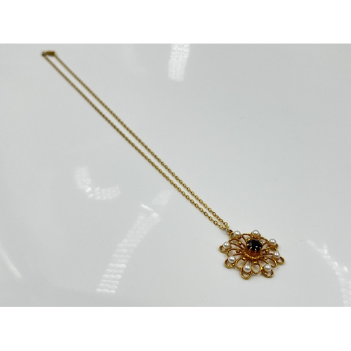 1128 - A yellow metal chain necklace with hallmarked London 9ct gold garnet and seed pearl pendant, dated 1... 