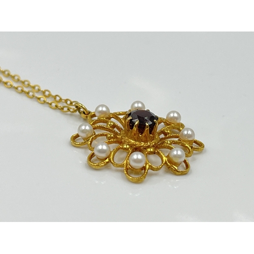 1128 - A yellow metal chain necklace with hallmarked London 9ct gold garnet and seed pearl pendant, dated 1... 