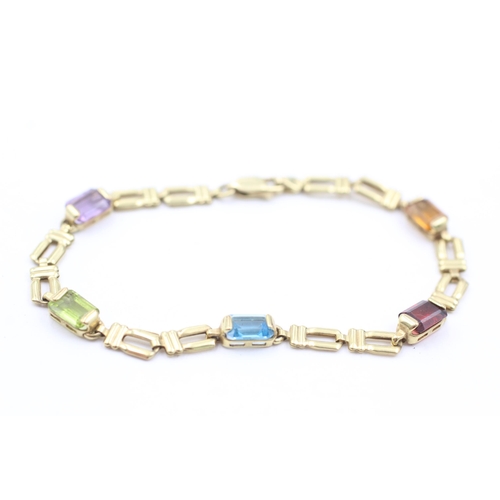 1038 - A 9ct gold garnet, peridot, topaz, citrine and amethyst bracelet - approx. gross weight 4.6 grams