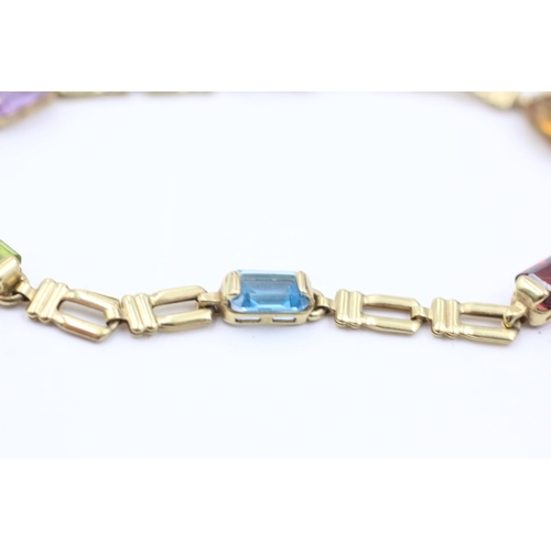 1038 - A 9ct gold garnet, peridot, topaz, citrine and amethyst bracelet - approx. gross weight 4.6 grams