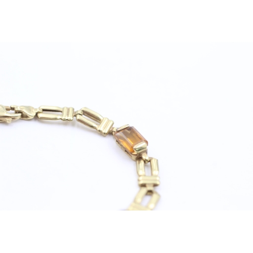 1038 - A 9ct gold garnet, peridot, topaz, citrine and amethyst bracelet - approx. gross weight 4.6 grams