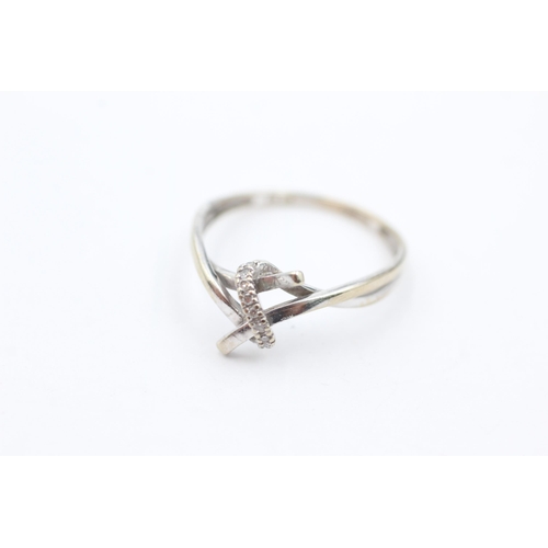 1040 - A 9ct white gold diamond set stylised knot ring, size O½ - approx. gross weight 1.4 grams