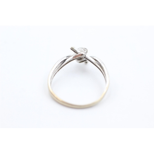 1040 - A 9ct white gold diamond set stylised knot ring, size O½ - approx. gross weight 1.4 grams