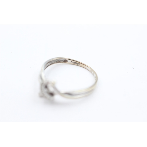 1040 - A 9ct white gold diamond set stylised knot ring, size O½ - approx. gross weight 1.4 grams