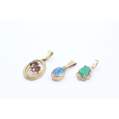 1042 - Three 9ct gold gemstone pendants, garnet, emerald and opal triplet - approx. gross weight 1.8 grams