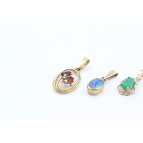 1042 - Three 9ct gold gemstone pendants, garnet, emerald and opal triplet - approx. gross weight 1.8 grams