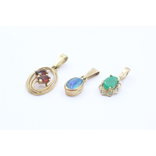 1042 - Three 9ct gold gemstone pendants, garnet, emerald and opal triplet - approx. gross weight 1.8 grams