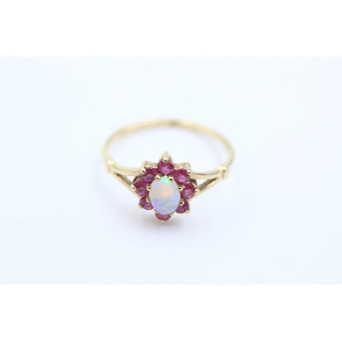 1044 - A 9ct gold opal and ruby ring, size M½ - approx. gross weight 1.4 grams