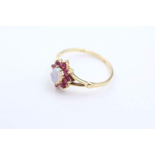 1044 - A 9ct gold opal and ruby ring, size M½ - approx. gross weight 1.4 grams