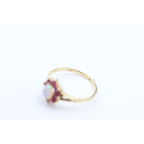 1044 - A 9ct gold opal and ruby ring, size M½ - approx. gross weight 1.4 grams