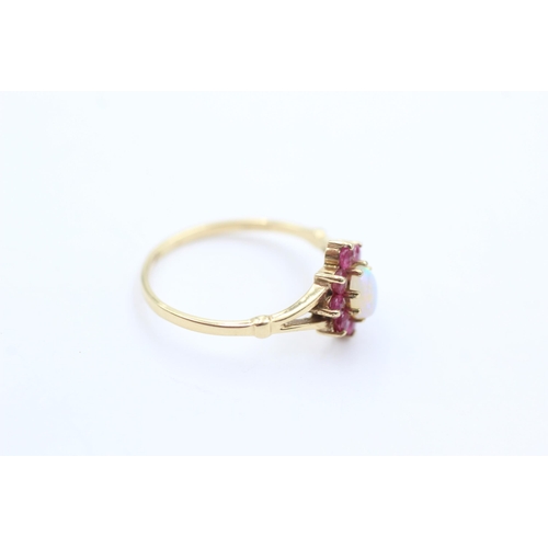 1044 - A 9ct gold opal and ruby ring, size M½ - approx. gross weight 1.4 grams