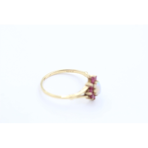 1044 - A 9ct gold opal and ruby ring, size M½ - approx. gross weight 1.4 grams