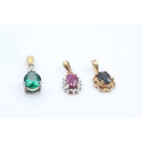 1050 - Three 9ct gold gemstone pendants, sapphire, ruby and synthethic emerald and diamond - approx. gross ... 