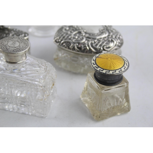 1238 - Eight hallmarked sterling silver and glass vanity jars