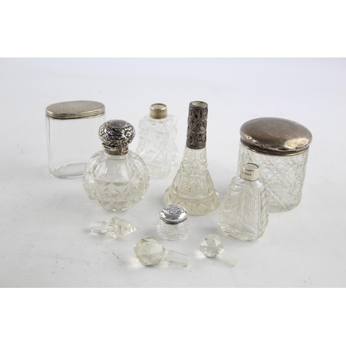 1239 - Seven hallmarked sterling silver and glass vanity jars