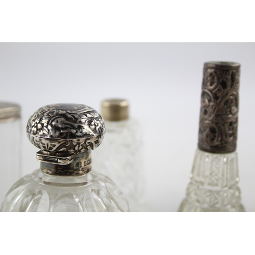 1239 - Seven hallmarked sterling silver and glass vanity jars