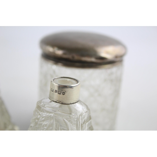 1239 - Seven hallmarked sterling silver and glass vanity jars