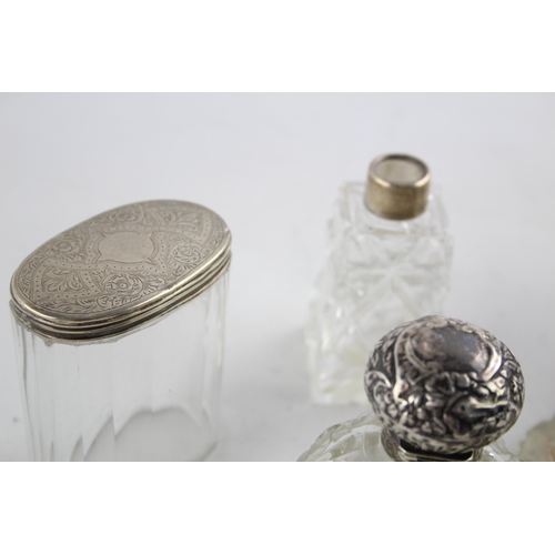 1239 - Seven hallmarked sterling silver and glass vanity jars