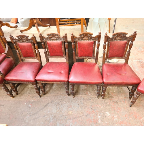 62 - A set of seven late Victorian carved oak and red vinyl dining chairs