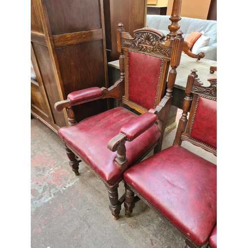 62 - A set of seven late Victorian carved oak and red vinyl dining chairs