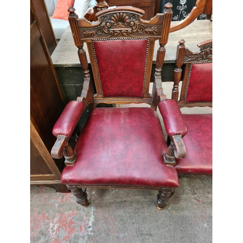 62 - A set of seven late Victorian carved oak and red vinyl dining chairs