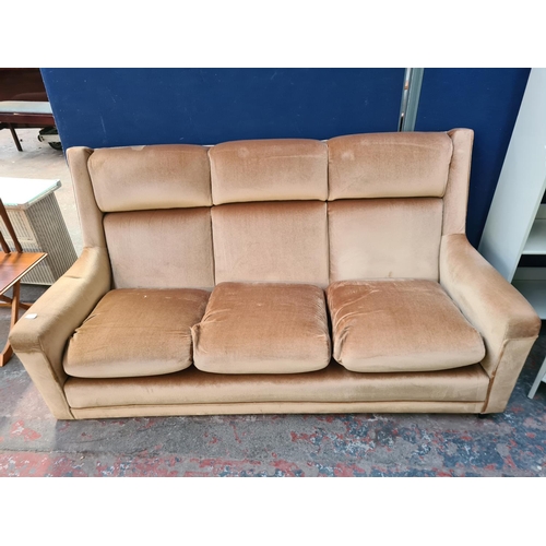 62D - A mid 20th century velvet upholstered three seater sofa