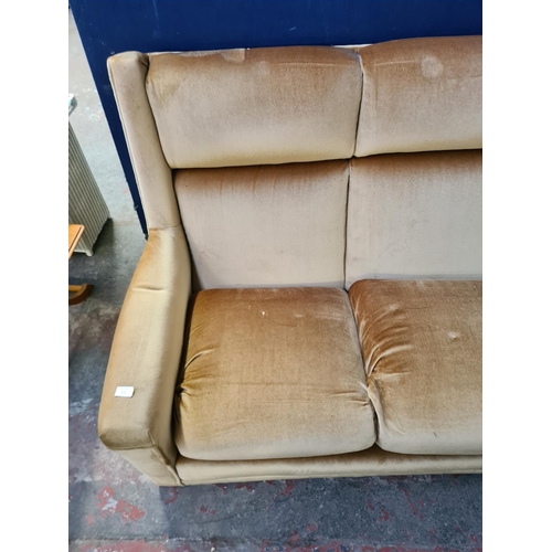 62D - A mid 20th century velvet upholstered three seater sofa