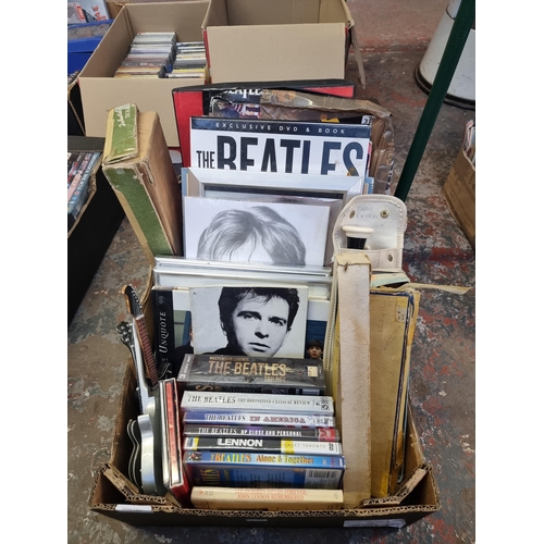 532 - A box containing The Beatles memorabilia and DVDs, guitar ornaments, recorders etc.