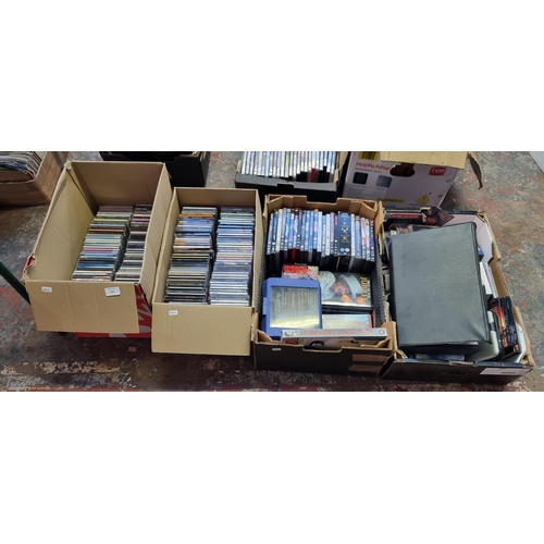 535 - Four boxes containing a collection of CDs and DVDs - see images for titles