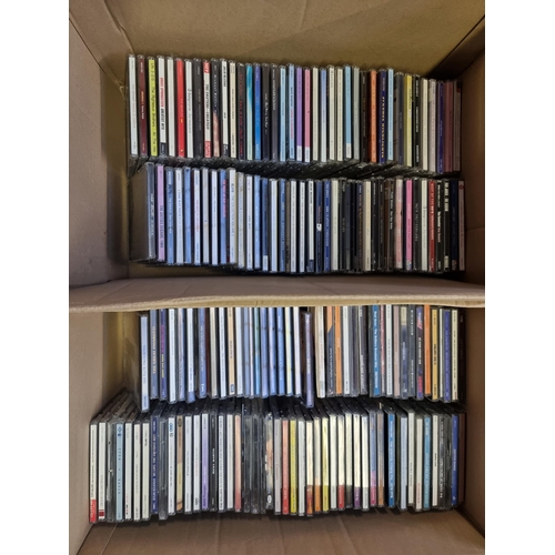 535 - Four boxes containing a collection of CDs and DVDs - see images for titles