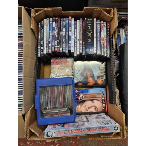 535 - Four boxes containing a collection of CDs and DVDs - see images for titles