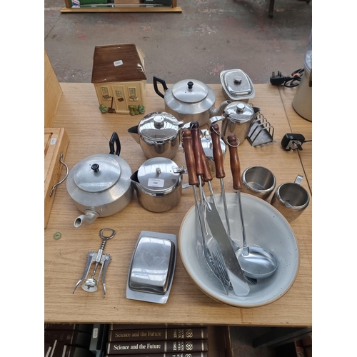 560 - A collection of kitchen items to include ceramic biscuit storage, Mason Cash mixing bowl, stainless ... 