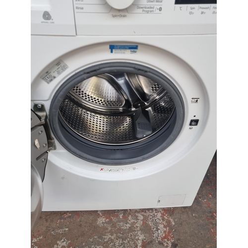 580 - A Beko WDB7426R1W 7kg wash 4kg wash and dry Bluetooth washing machine - approx. 60cm wide