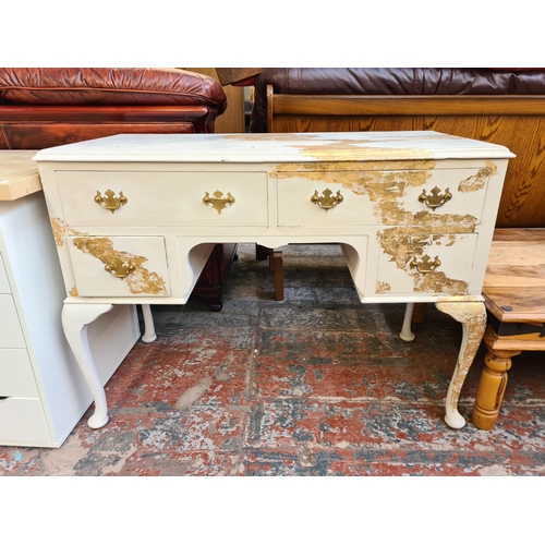 92 - A French style white and gold painted dressing table with four drawers and cabriole supports - appro... 