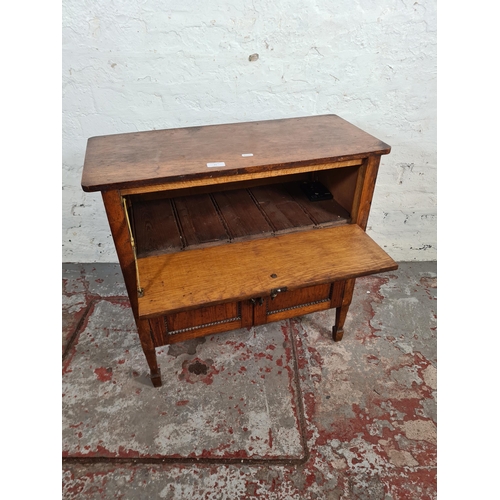 117 - A 1930s oak cabinet with fall front, two lower cupboard doors and beaded decoration - approx. 66cm h... 