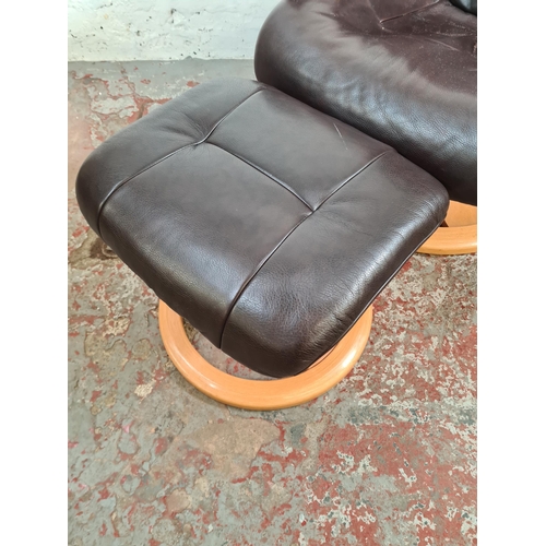 128 - A John Lewis brown leather and beech swivel reclining arm chair and foot stool - approx. 100cm high ... 