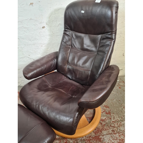 128 - A John Lewis brown leather and beech swivel reclining arm chair and foot stool - approx. 100cm high ... 